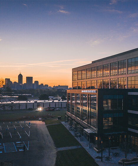 Image of building at sunrise with Indianapolis skyline